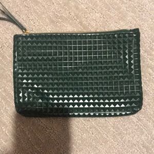 A green makeup bag with a pink inside.